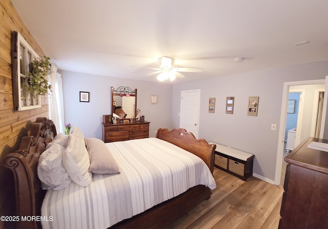 bedroom with ceiling fan and wood-type flooring