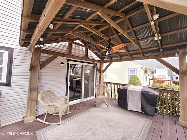 wooden terrace with a gazebo, ceiling fan, and grilling area