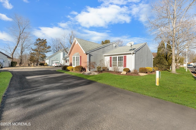 view of front of property featuring a garage and a front yard