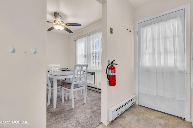 dining space featuring ceiling fan and a baseboard radiator