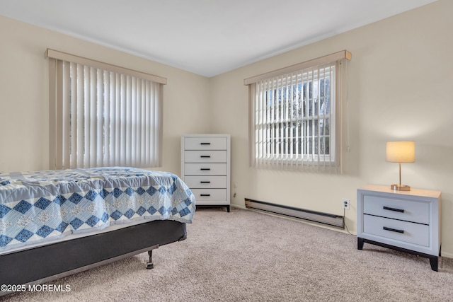 carpeted bedroom featuring a baseboard heating unit