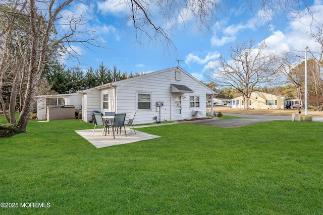 back of property featuring a yard and a patio