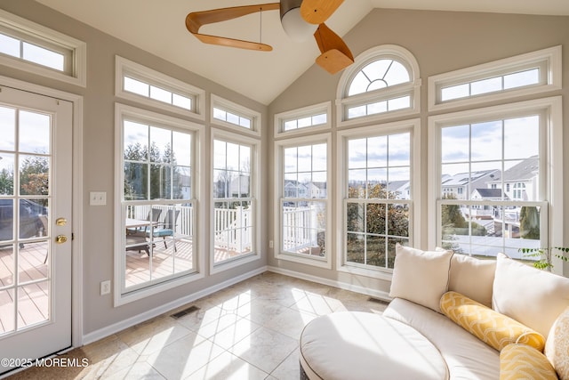 sunroom / solarium featuring plenty of natural light, ceiling fan, and vaulted ceiling