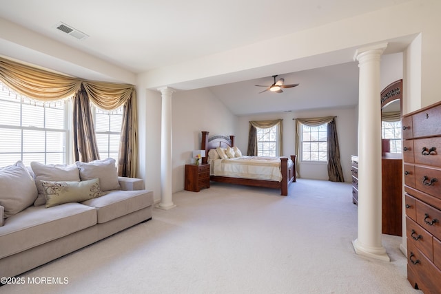 carpeted bedroom with ceiling fan, vaulted ceiling, and ornate columns