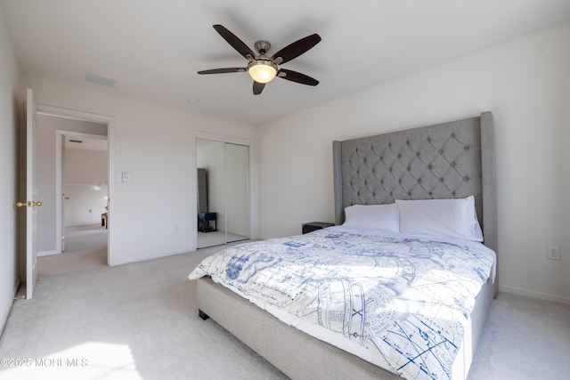 carpeted bedroom with ceiling fan and a closet