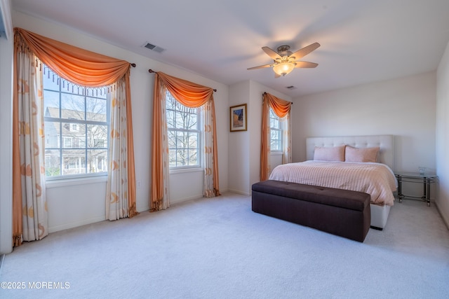 bedroom with multiple windows, ceiling fan, and carpet flooring