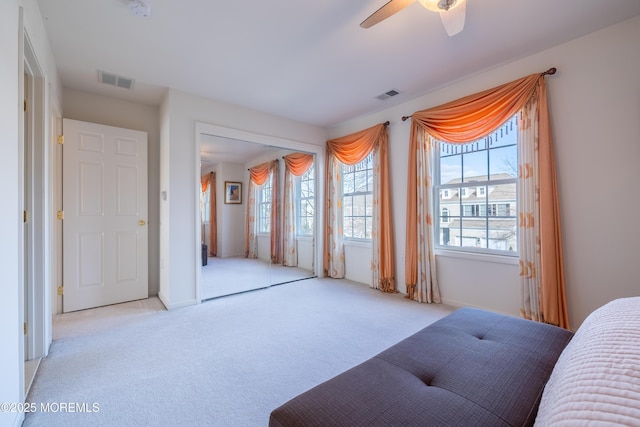 bedroom featuring ceiling fan and light carpet