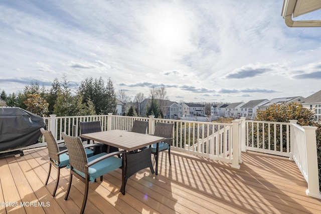 wooden deck featuring a grill