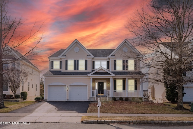 view of front of property featuring a garage and covered porch