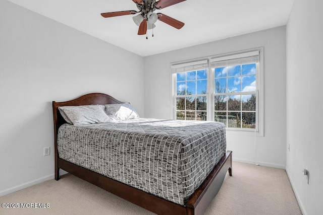 bedroom featuring light colored carpet and ceiling fan