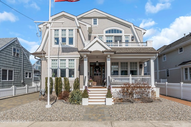 view of front of property with a balcony and covered porch