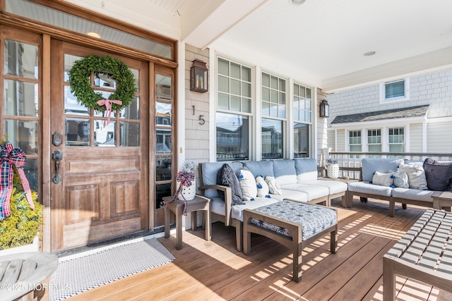 wooden terrace with a porch and outdoor lounge area