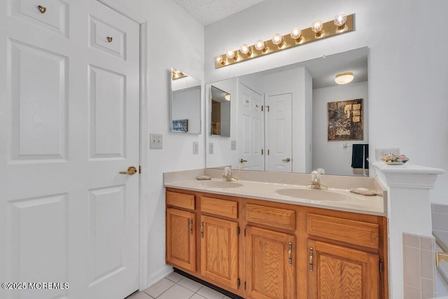 bathroom with vanity, tile patterned flooring, and a textured ceiling