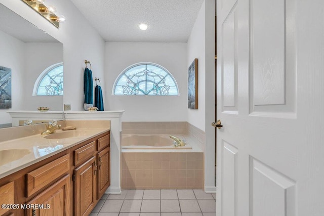 bathroom with tile patterned floors, tiled bath, a textured ceiling, and plenty of natural light