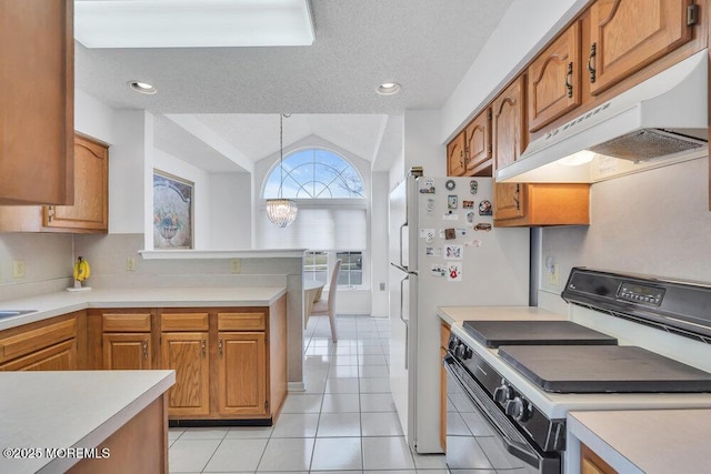 kitchen with lofted ceiling, light tile patterned floors, range with gas stovetop, a textured ceiling, and decorative light fixtures