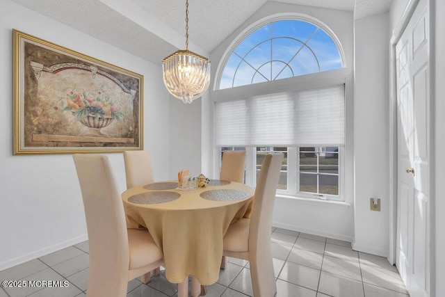 tiled dining room with lofted ceiling, plenty of natural light, a notable chandelier, and a textured ceiling