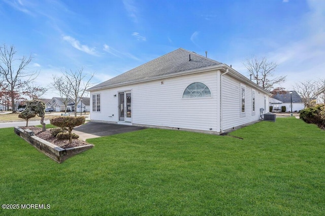 back of property with a yard, central AC unit, and a patio area