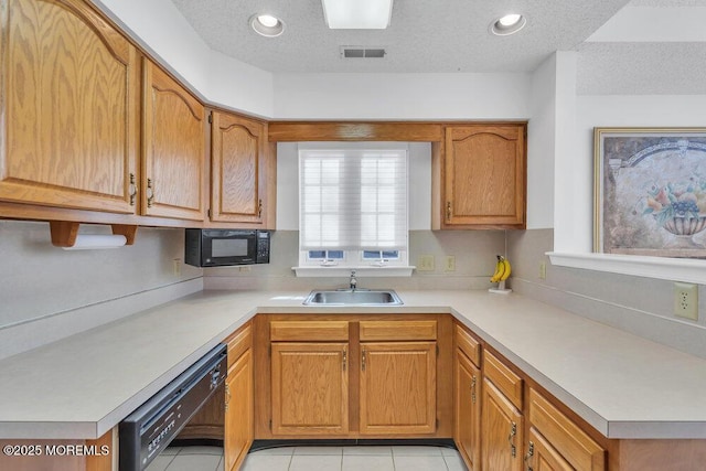 kitchen with sink, light tile patterned floors, black appliances, and a textured ceiling