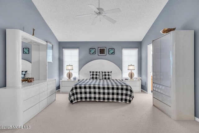 carpeted bedroom with ceiling fan, lofted ceiling, and a textured ceiling