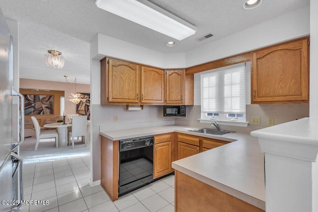 kitchen featuring sink, hanging light fixtures, black appliances, light tile patterned flooring, and kitchen peninsula