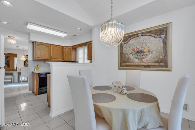 dining area featuring light tile patterned floors and a notable chandelier