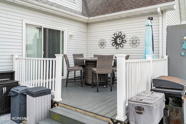 deck with area for grilling and an outdoor bar