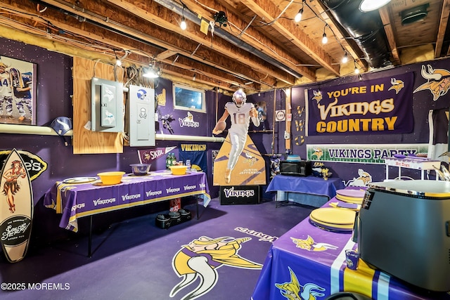 game room featuring concrete flooring and electric panel