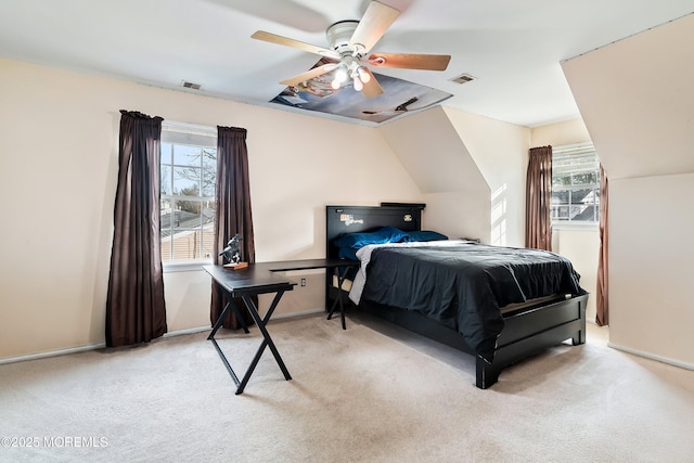 bedroom featuring ceiling fan, light colored carpet, and multiple windows