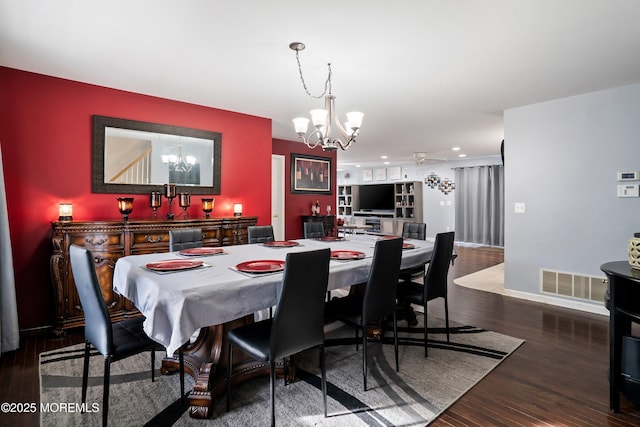 dining space featuring hardwood / wood-style floors and a notable chandelier