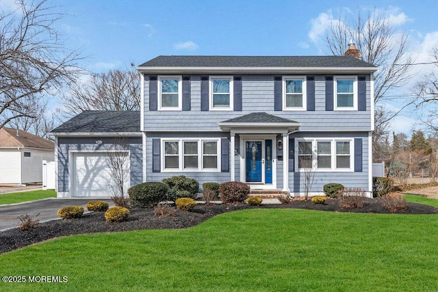 view of front facade with a front yard and a garage