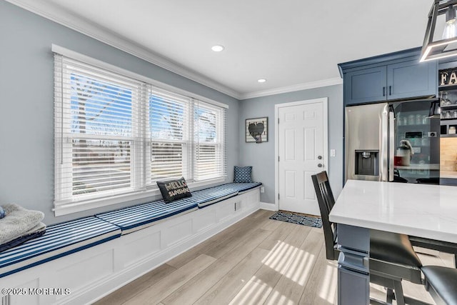 office space with ornamental molding and light hardwood / wood-style flooring