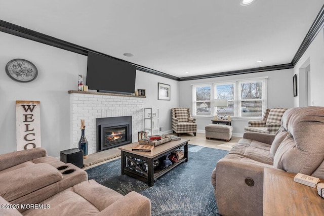 living room featuring hardwood / wood-style flooring, crown molding, and a fireplace