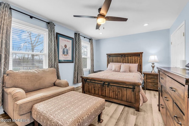 bedroom with light wood-type flooring and ceiling fan