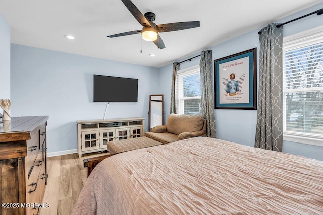 bedroom with ceiling fan and light hardwood / wood-style flooring