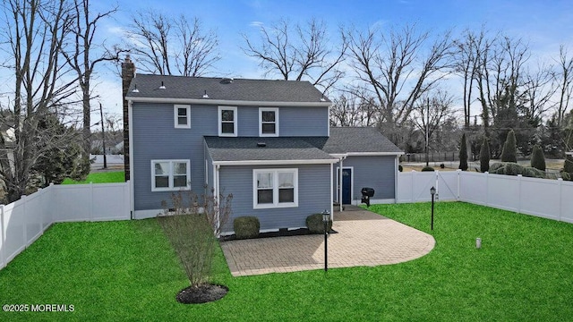 back of property with a patio and a lawn