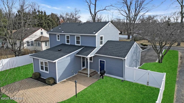 view of property with a front lawn and a patio area