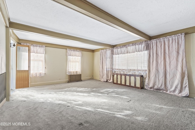 unfurnished room featuring beam ceiling, a textured ceiling, and carpet