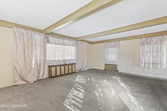 carpeted spare room with beamed ceiling and radiator heating unit