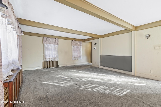 carpeted spare room featuring beamed ceiling and radiator heating unit