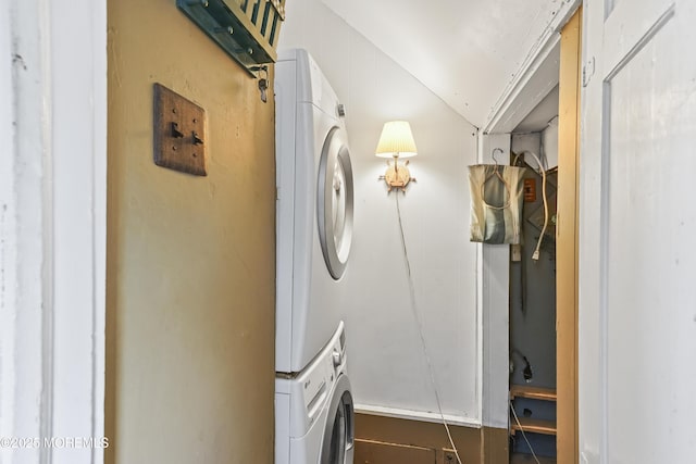 laundry area featuring stacked washer / drying machine