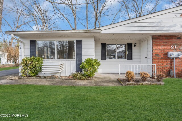 view of exterior entry with a yard