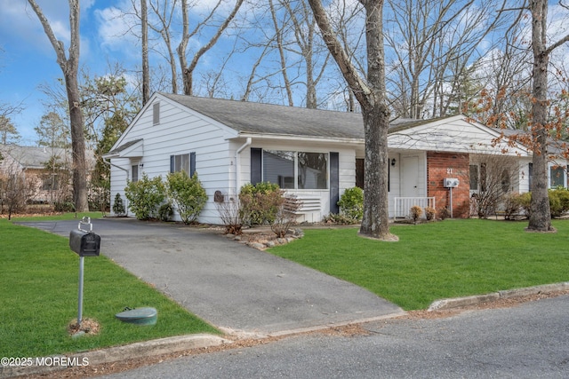 ranch-style home with a front lawn