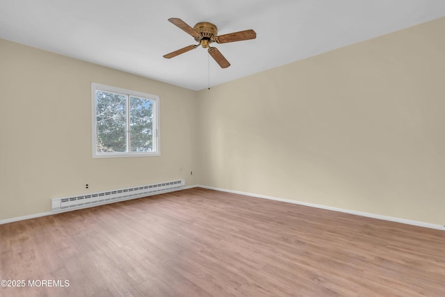 empty room featuring baseboard heating, ceiling fan, and light wood-type flooring