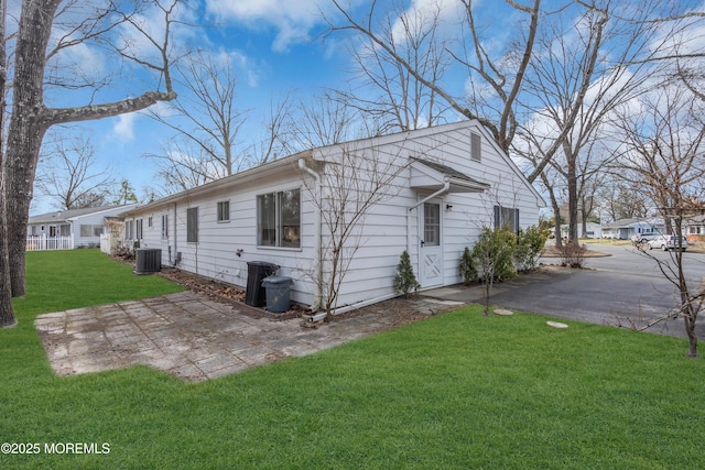 view of property exterior featuring cooling unit, a yard, and a patio