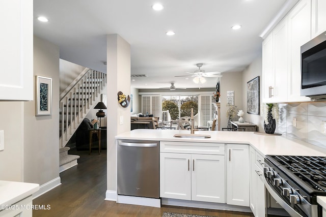 kitchen with white cabinetry, appliances with stainless steel finishes, and kitchen peninsula