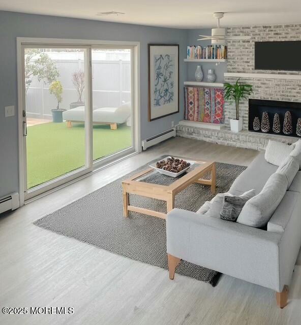 living room with a fireplace, wood-type flooring, and baseboard heating