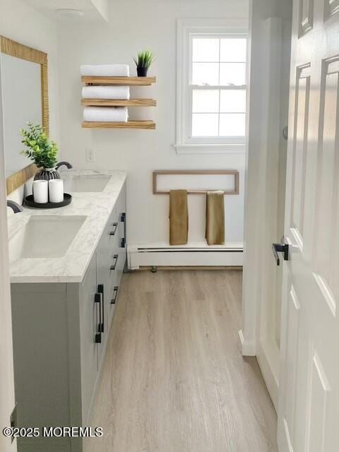 bathroom featuring baseboard heating, vanity, and hardwood / wood-style flooring