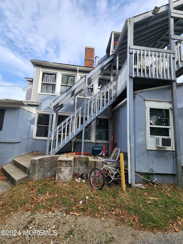 rear view of property with cooling unit