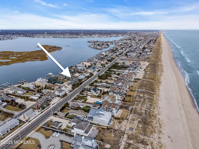 bird's eye view featuring a residential view, a view of the beach, and a water view