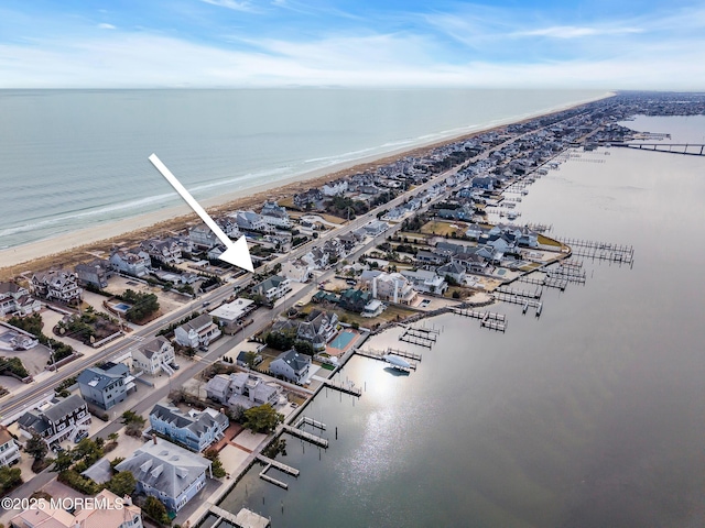 birds eye view of property with a beach view and a water view